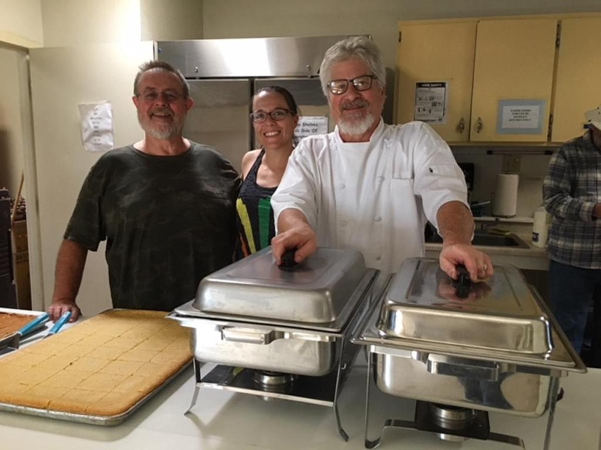 Phil Lang, left, from Bon Temps Creole Café, prepared a ham meal with all the trimmings for Thanksgiving dinner at the People’s Kitchen. The meal was served at the Prado Day Center. More than 80 people enjoyed the meal.