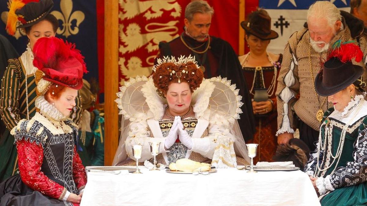 Queen Elizabeth I, played by actress Thena MacArthur, and her court hold a prayer before eating lunch during the Central Coast Renaissance Festival at Laguna Lake Park.
Photo by Joe Johnston 07-13-17
