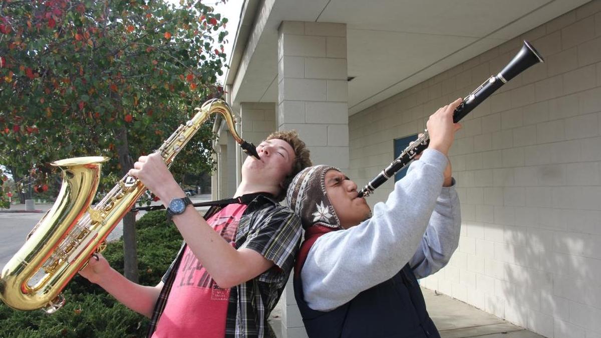 Morro Bay High School music students John Mielke, left, and Mario Linos show off their enthusiasm after being awarded music lesson scholarships from the Mary Monroe Be Instrumental Program.
