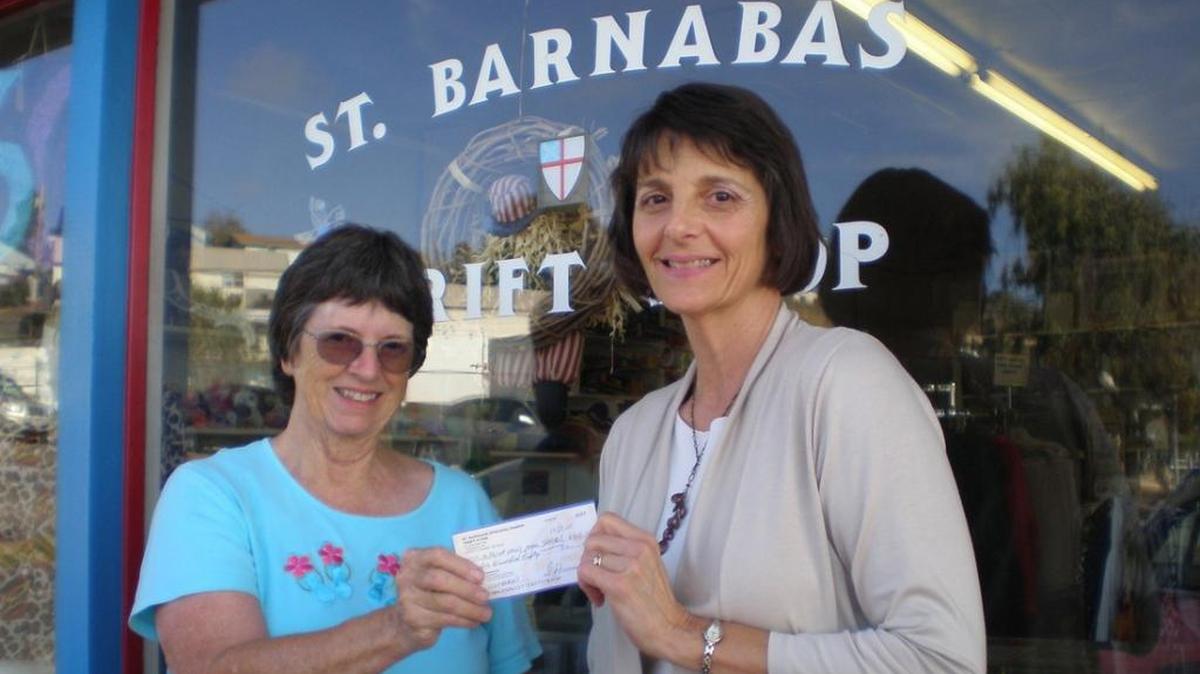 St. Barnabas Church Thrift Shop volunteer Marilyn Cockshott, left, presents a donation from the thrift shop to Grace McIntosh, deputy director of Community Action Partnership of SLO County, for the Maxine Lewis Memorial Shelter.