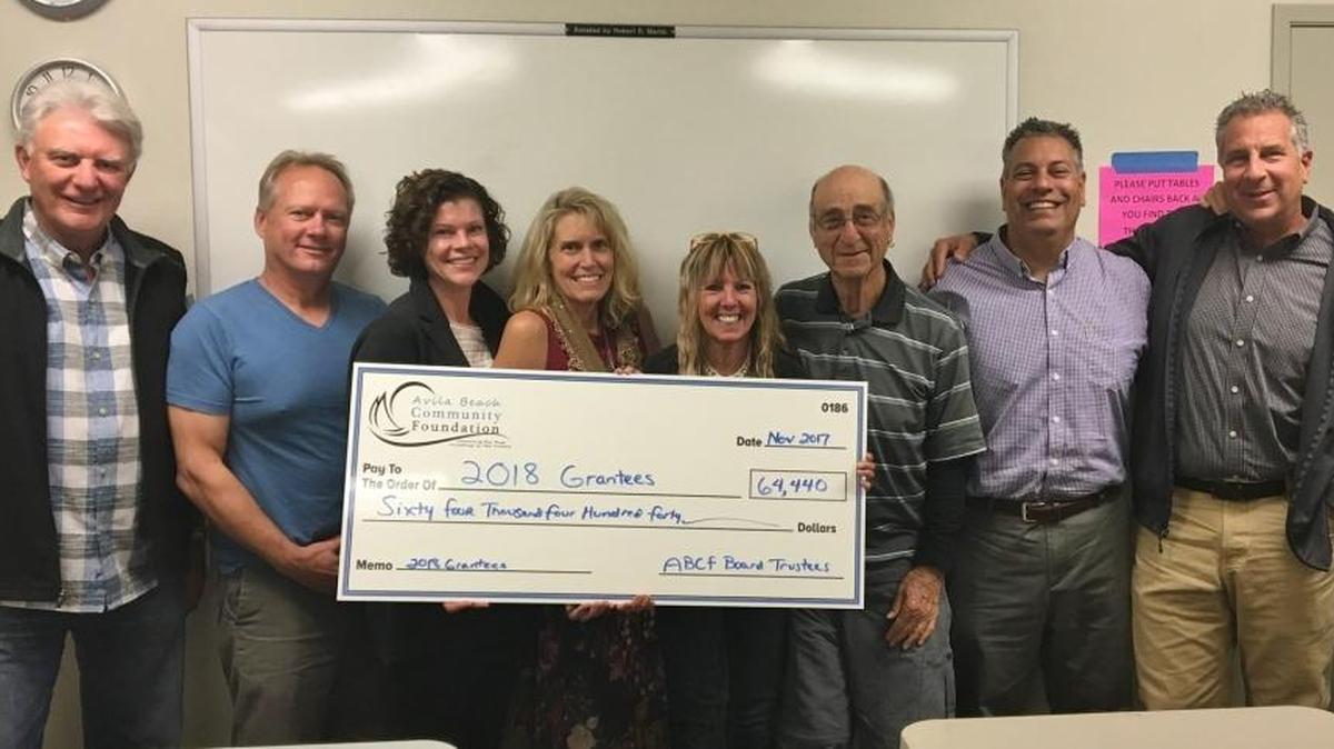 From left, Avila Beach Foundation board of trustee members Paul Prather, Gary Maier, Ellen Pitrowski, Cyndy Lakowske, Bev Aho, Saul Goldberg, Rick Rowe, Mike Ginn and foundation Executive Director Rick Cohen celebrate the recent donation of more than $64,000.