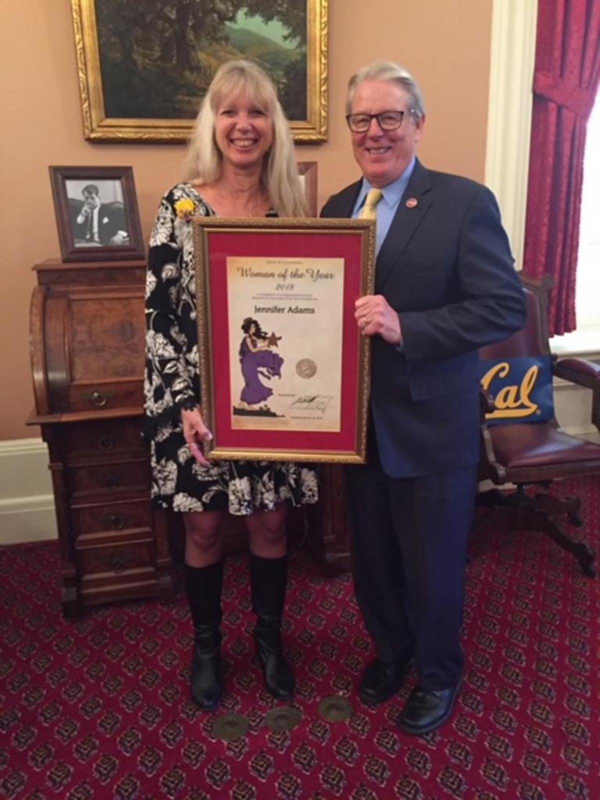 Jennifer Adams receives her 2018 District 17 Woman of the Year award from State Senate Majority Leader Bill Monning.