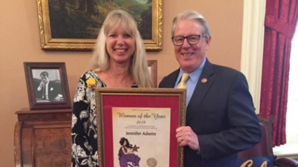 Jennifer Adams, left, receives her 2018 District 17 Woman of the Year award from State Senate Majority Leader Bill Monning, right.