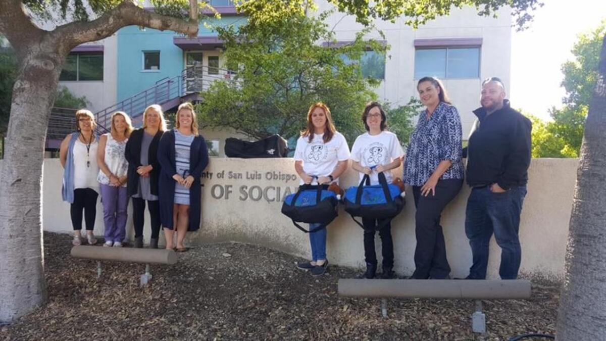 Cal Poly students Adrian Lindsey and Jordyn Reis (pictured with blue bags) raised nearly $2,000 for foster children in San Luis Obispo County.