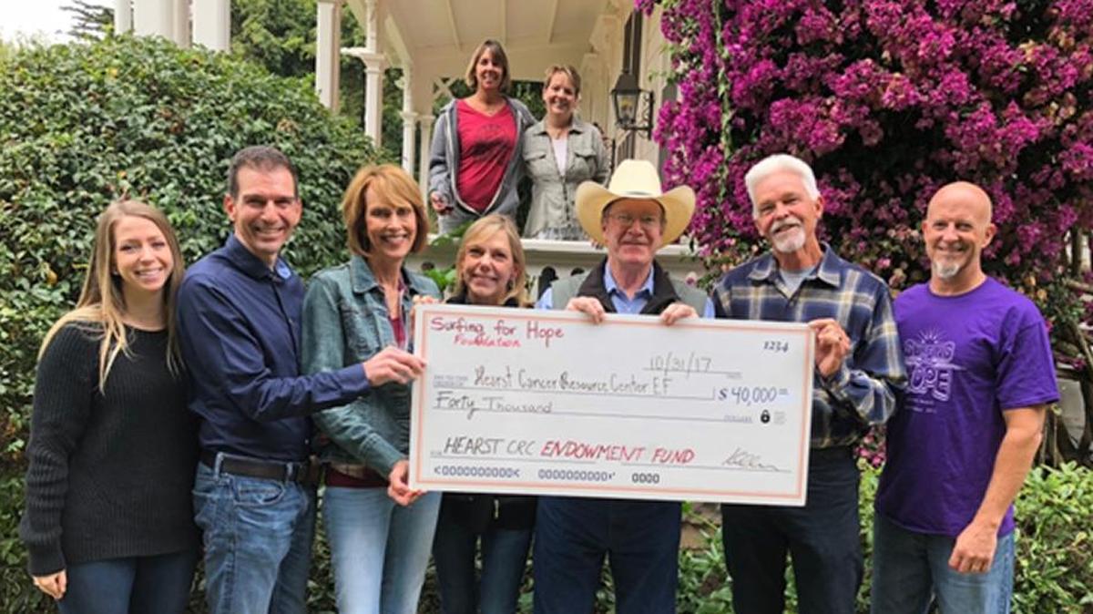 Celebrating at a Surfing for Hope fundraiser are, from left, Tracy Timmons, Tom Vendegna, Bev Kirkhart, Barbara and Steve Hearst, Bob Voglin and Tom Spillane. In the back row are Karen Allen and Gloria Caine.