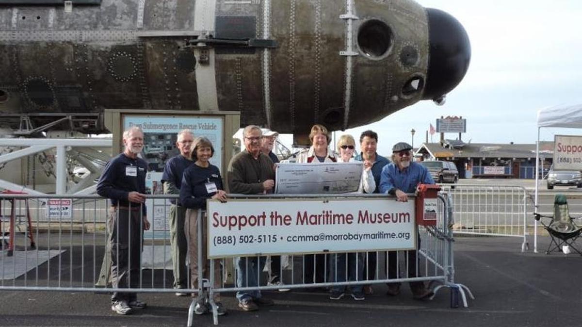 Central Coast Maritime Museum Association board members accept a donation from Morro Bay Harbor Festival board members to benefit the Morro Bay Maritime Museum.