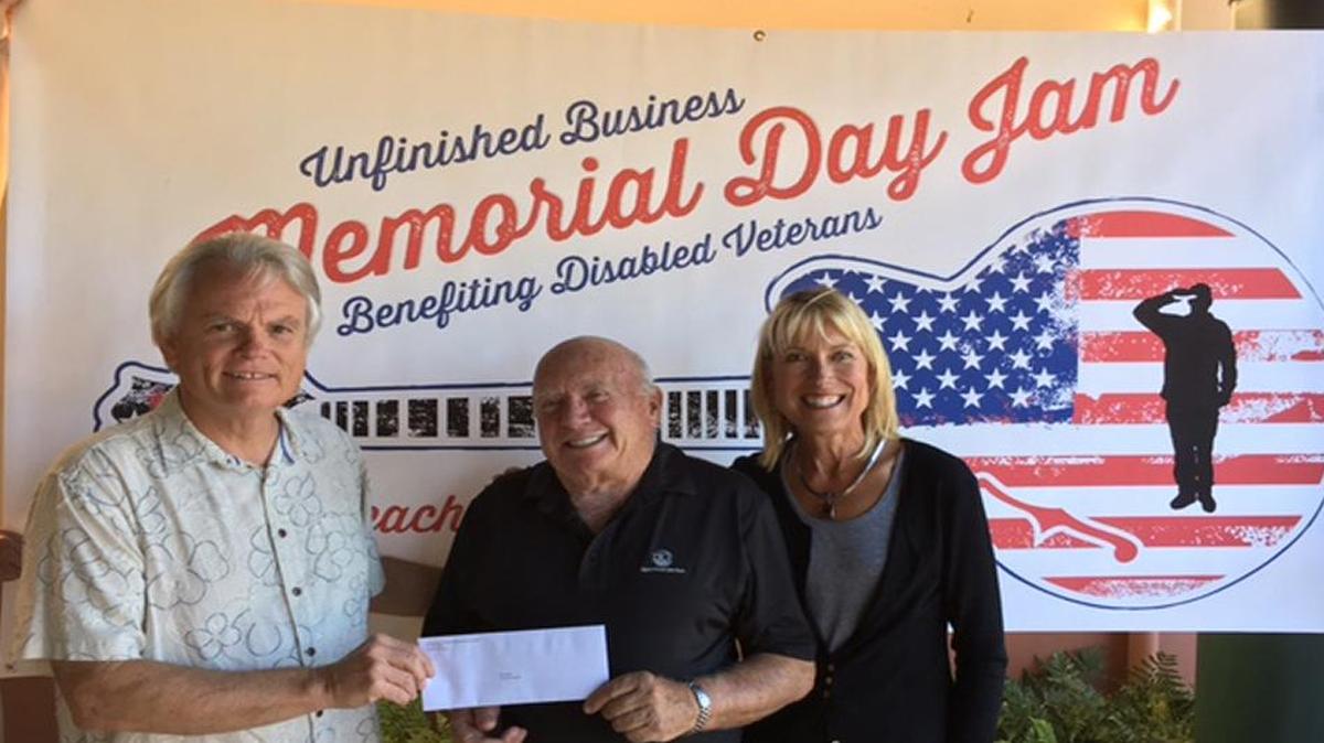 Jon Monett, center, chairman of Quality of Life Plus, accepts a check in the amount of $2,000 from Ed Miller and Barbara Nicholson from proceeds raised at the Unfinished Business Memorial Day Jam at the Avila Beach Golf Resort.