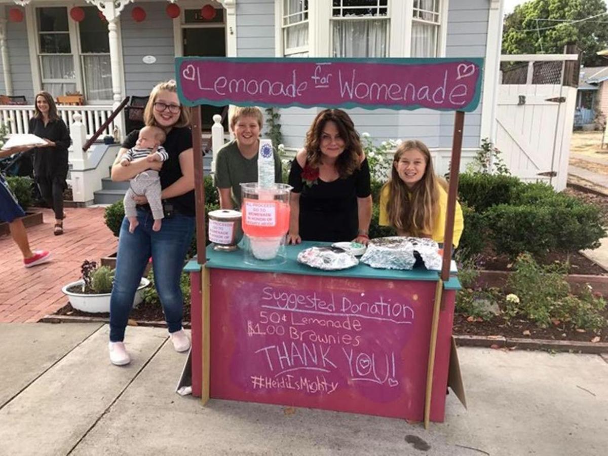 Calista Stewart’s Lemonade for Womenade stand at San Luis Obispo Mayor Heidi Harmon’s potluck birthday benefit party earned $93. From left are Gwen Stewart holding Boone Stewart, Mayor Heidi Harmon and Calista Stewart.