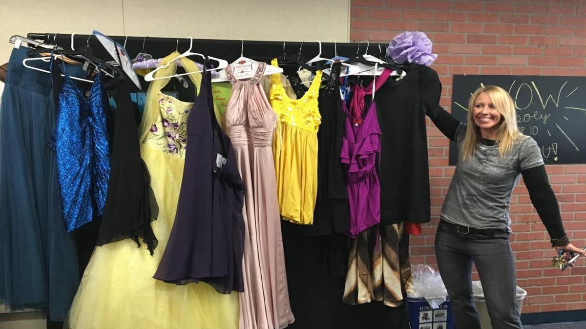 Lori Klemowicz of the Children’s Resource Network displays formal dresses donated by Diablo Canyon nuclear power plant employees for disadvantaged teens at Nipomo High School.