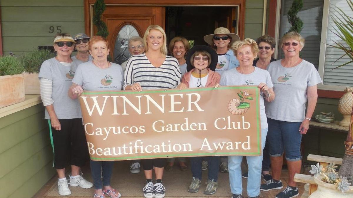 Members of Cayucos Garden Club present the owner of Cayucos Sunset Inn, Alexis Mankin, with the 2017 Beautification Award.