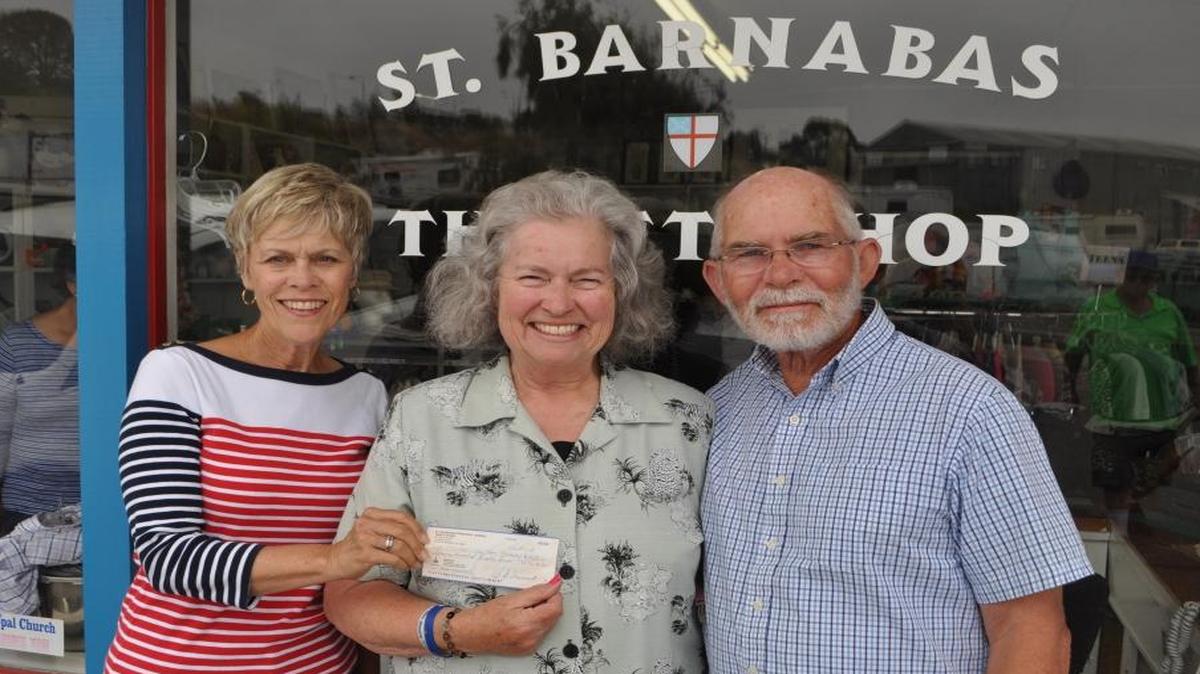 Saint Barnabas Thrift Shop volunteers Pam DeTilla, left, and Paul DeTilla, right, present a $1,185 check to Kathy Goering, treasurer for Five Cities Christian Women.