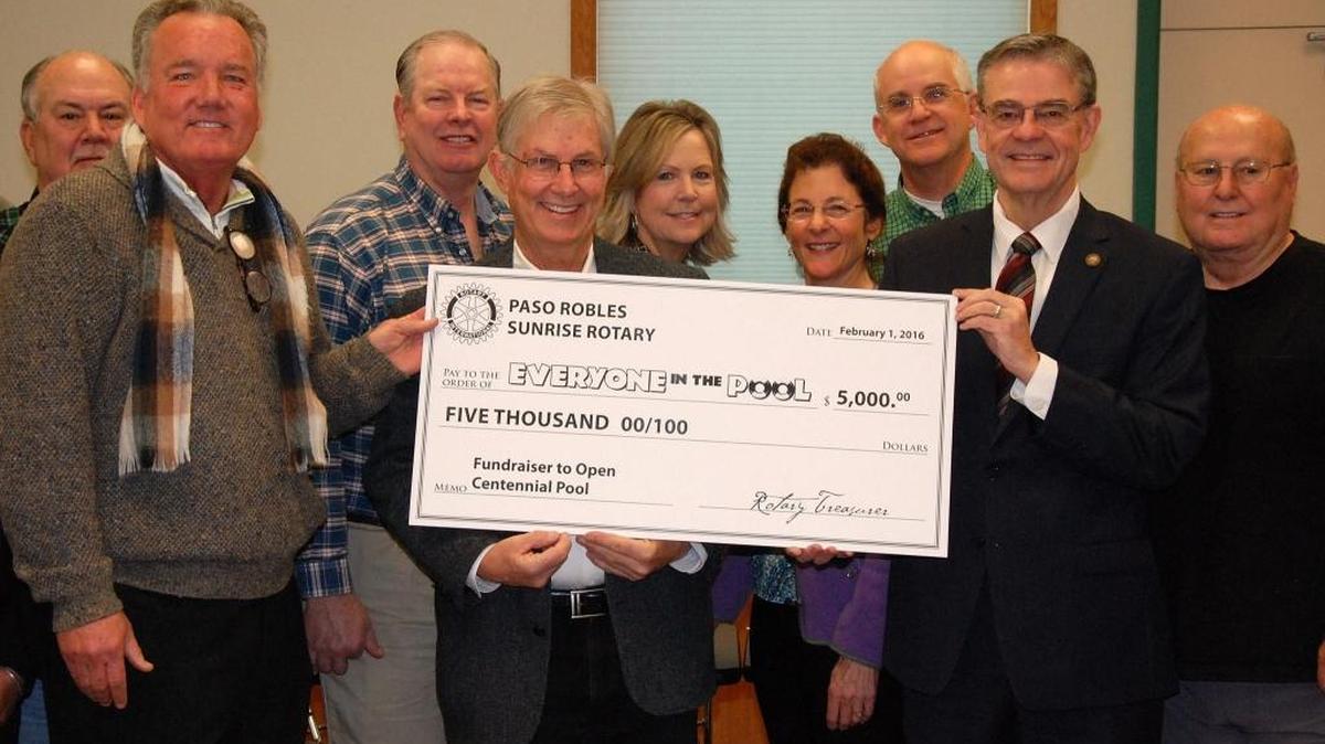 Paso Robles Mayor Steve Martin, second from right, receives a donation from the Paso Robles Sunrise Rotary Club for the mayor’s fundraiser Everyone in the Pool. Paso Robles City Councilman Steve Gregory, center, is chairman of the event committee.