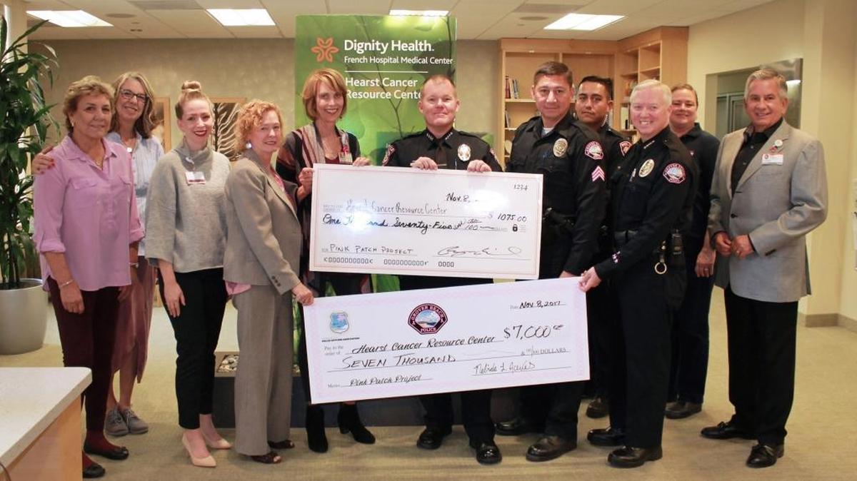 From left, Carol Thom, Jackie Starr, Tracy Timmons, Rosey Parks, Officer Beverly Kirkhart, Chief Bryan Millard, Officer Juan Carranza, Sgt. Celis Rabena, Chief John Peters Devon Polit and Alan Iftiniuk celebrate raising $8,075 from the Pink Patch Project to benefit French Hospital Medical Center’s Hearst Cancer Resource Center.