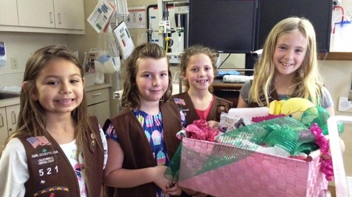 From left, Girl Scout Brownies Lilly Gracia, Bailey Morgan, Kendall Thomson and Makenna Crosson show the gift basket their troop made for a new mom at French Hospital Medical Center.