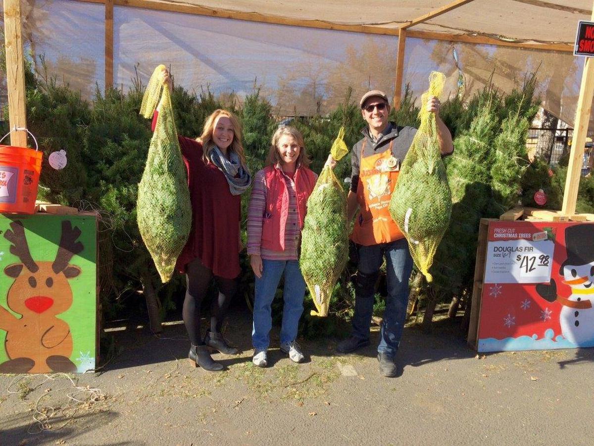 Atascadero Home Depot’s Justin Sears, right, assists Family Ties staff Lizzy Dembosz, left, and Marta Nielsen with a donation of Christmas trees for Family Ties’ “Giving Thanks Feast.” Family Ties, a program of Seneca Family of Agencies, provides support and referrals for kin caregivers who care for another relative’s family member.