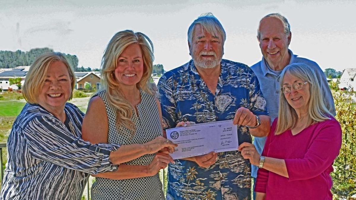 Supervisor Lynn Compton, second from left, presents a grant check in the amount of $1,000 to Michael Stephens, operations manager of Monarch Radio. Also shown, from left, is Monarch Radio’s Patti Haines, Howard Wishner and Catherine Kitcho.