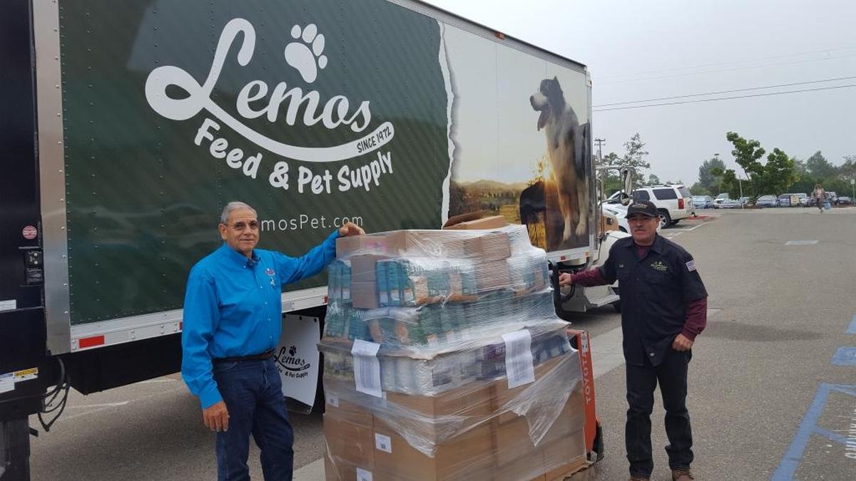Mike Lemos, from Lemos Feed & Pet Supply, left, donated a pallet of dog and cat food to Meals That Connect to be distributed to homebound seniors whose only companions are their treasured pet. Many seniors live below the poverty level and are unable to buy food.