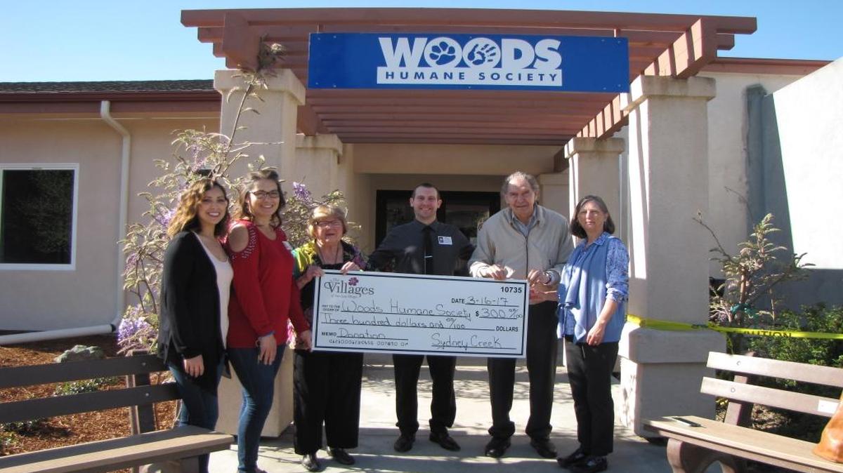 Residents in the memory care community at The Village at Sydney Creek recently made a donation to Woods Humane Society. Residents Barbara, third from left, and Ted, second from right, presented the celebratory check to Joy Miller, left, of Woods. From left, Krystal Cornejo, Anne-Marie Browder and Benjamin Morris of Sydney Creek also attended.