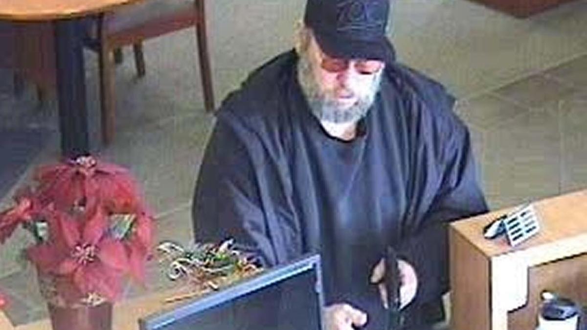A man is shown robbing Heritage Oaks Bank in San Luis Obispo on Monday, Jan. 4, 2016, in this image taken from surveillance video.