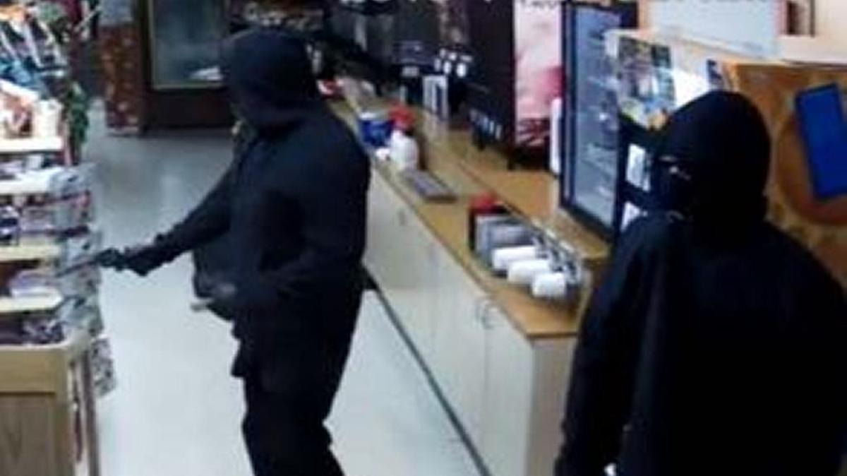A still image taken from security camera footage at Wayside Liquor showing two armed men who stole cash and alcohol from the store Saturday night.
