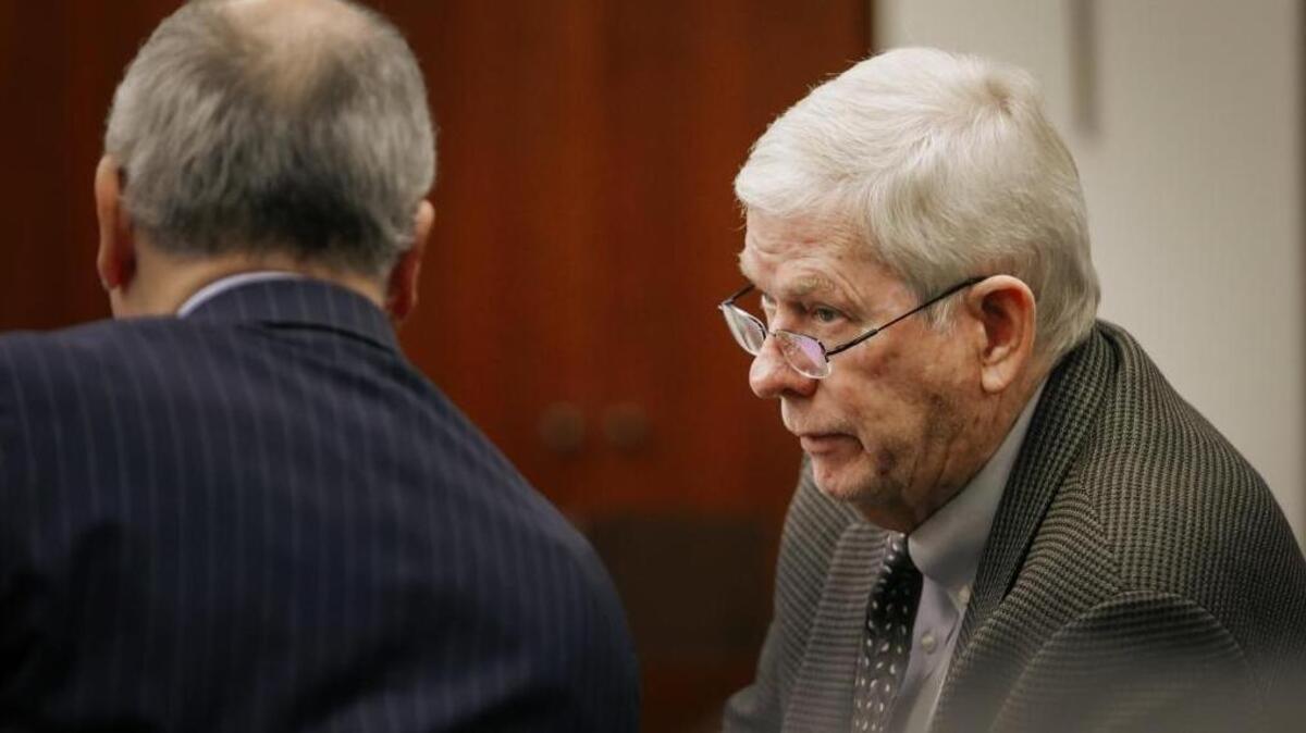 John Wallace, right, speaks to his attorney, Kenneth White, during Monday’s preliminary hearing in Santa Maria on Wallace’s felony conflict-of-interest charges.