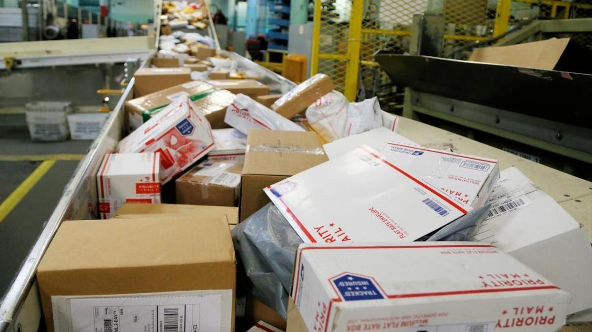 Packages travel on a conveyor belt for sorting at the main post office in Omaha, Nebraska, Thursday, Dec. 14, 2017.