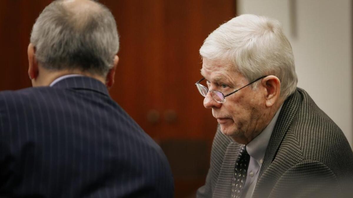 John Wallace, right, speaks to his attorney, Kenneth White, during Monday’s preliminary hearing in Santa Maria on Wallace’s felony conflict-of-interest charges. Wallace reached a plea agreement Tuesday with prosecutors.