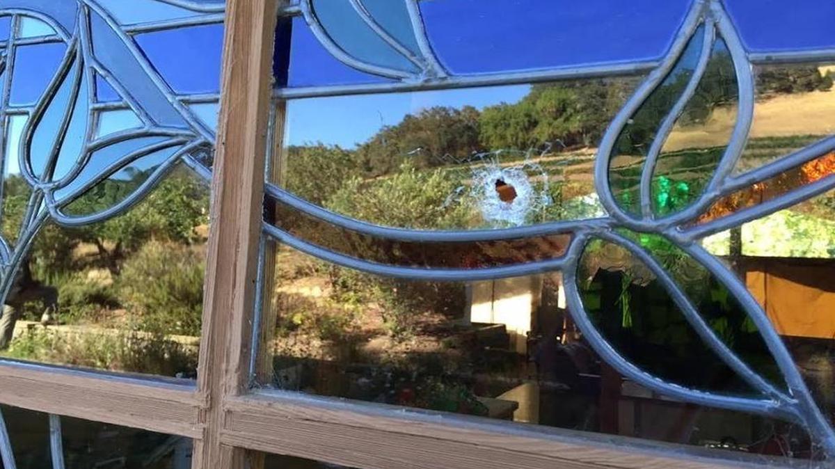 A bullet hole in a window at the scene of an alleged home invasion robbery July 20 in the 4700 block of See Ranch Lane in rural Templeton.