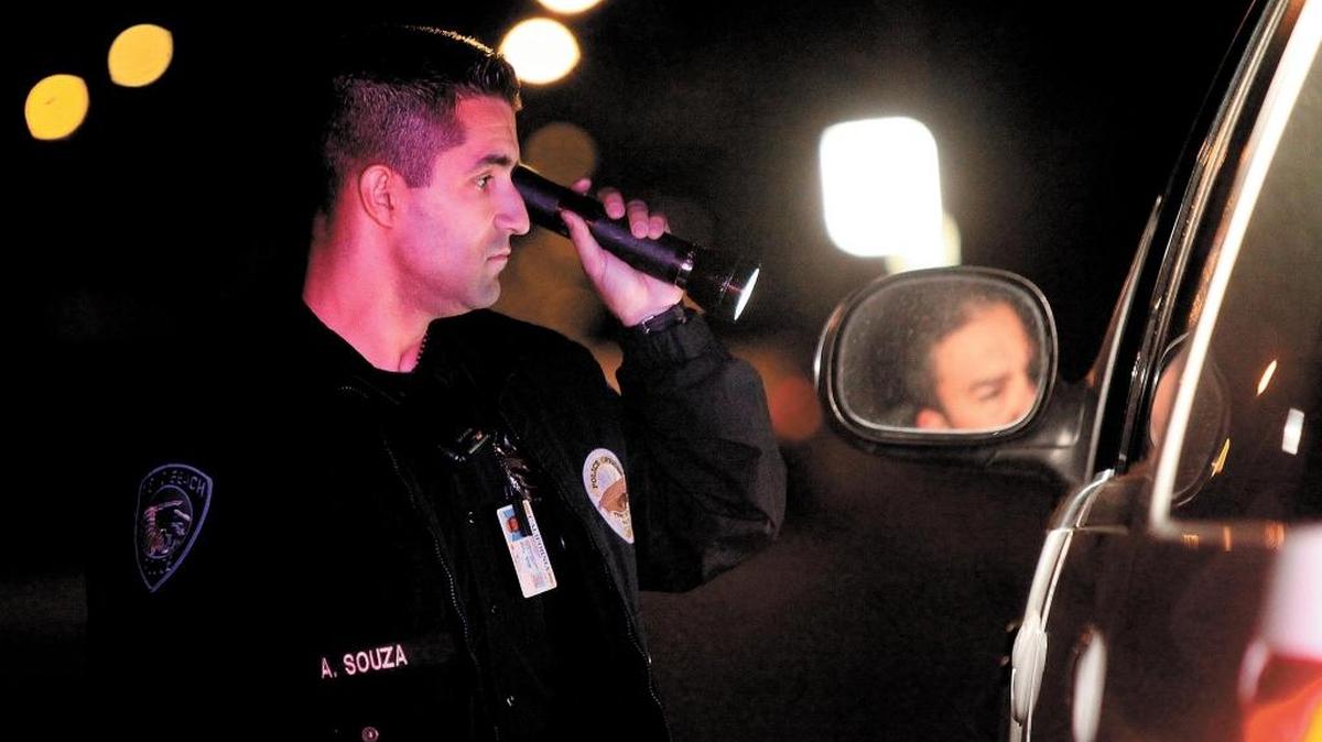 Pismo Beach, CA, police Cpl. Adrian Souza mans a DUI checkpoint in the city in December 2017. Since 2013, at least 11 current or retired law enforcement officers have been convicted of DUIs and other crimes, with many receiving significant reductions in their sentences.