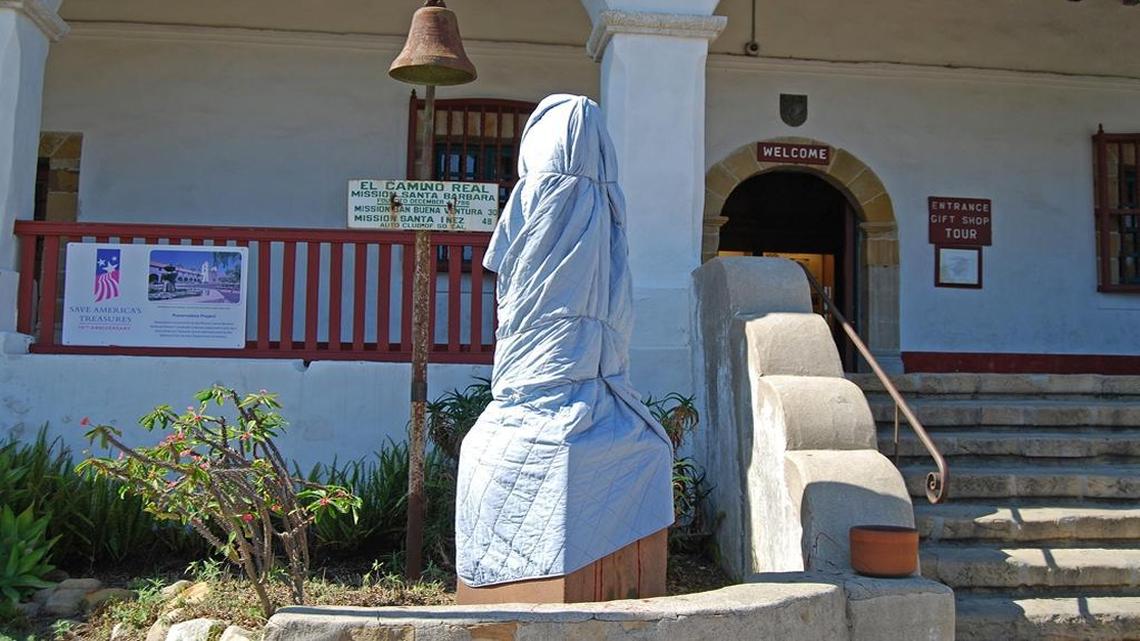 The statue of Junipero Serra at the Santa Barbara Mission is covered Monday after being vandalized.