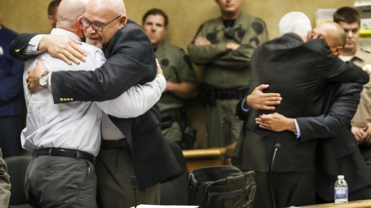 Former Salinas Valley State Prison guards Travis Woolf, left, and Sergio Aranda, right, hug their attorneys Thursday after being acquitted of manslaughter in the death of Alvaro Medrano following a fight outside the Elkhorn Bar in San Miguel on Sept. 7, 2014.