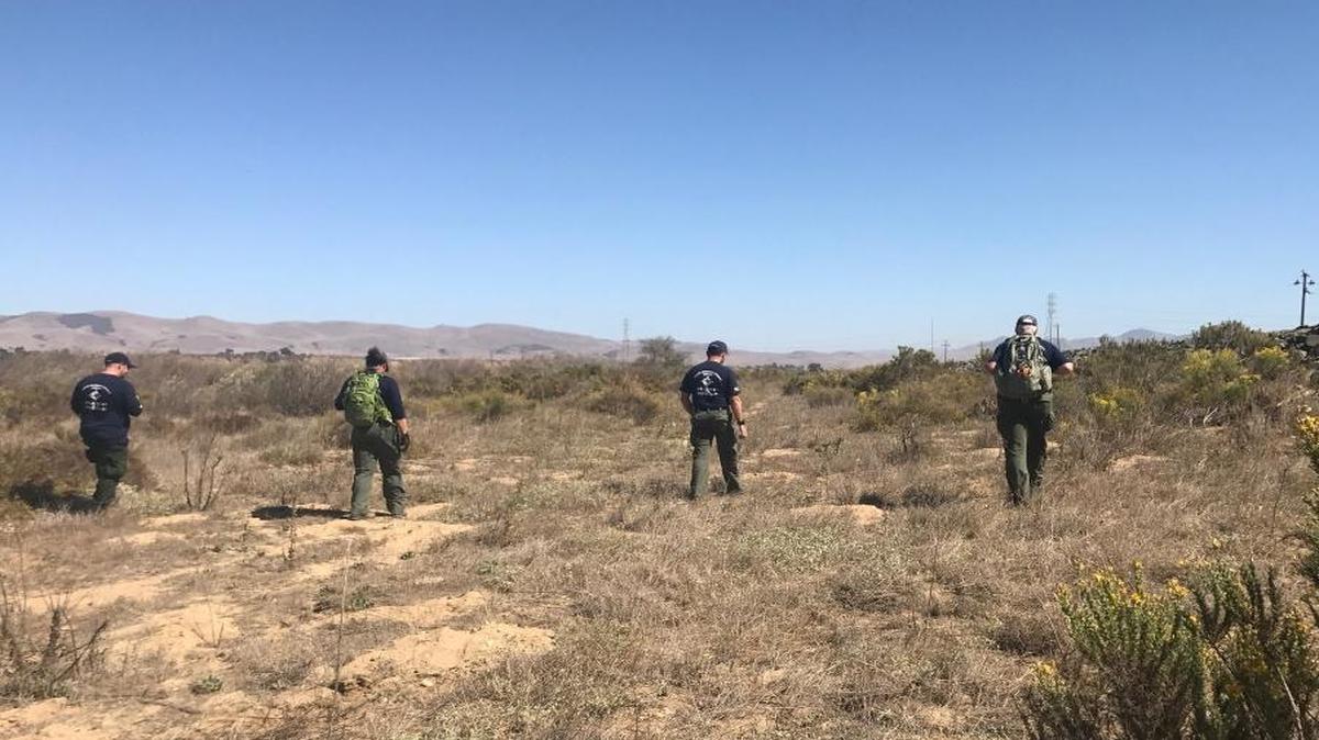 Investigators search the Santa Maria Riverbed on Monday, a day after a woman’s body was found there. Sheriff’s officials are calling the death “suspicious.”