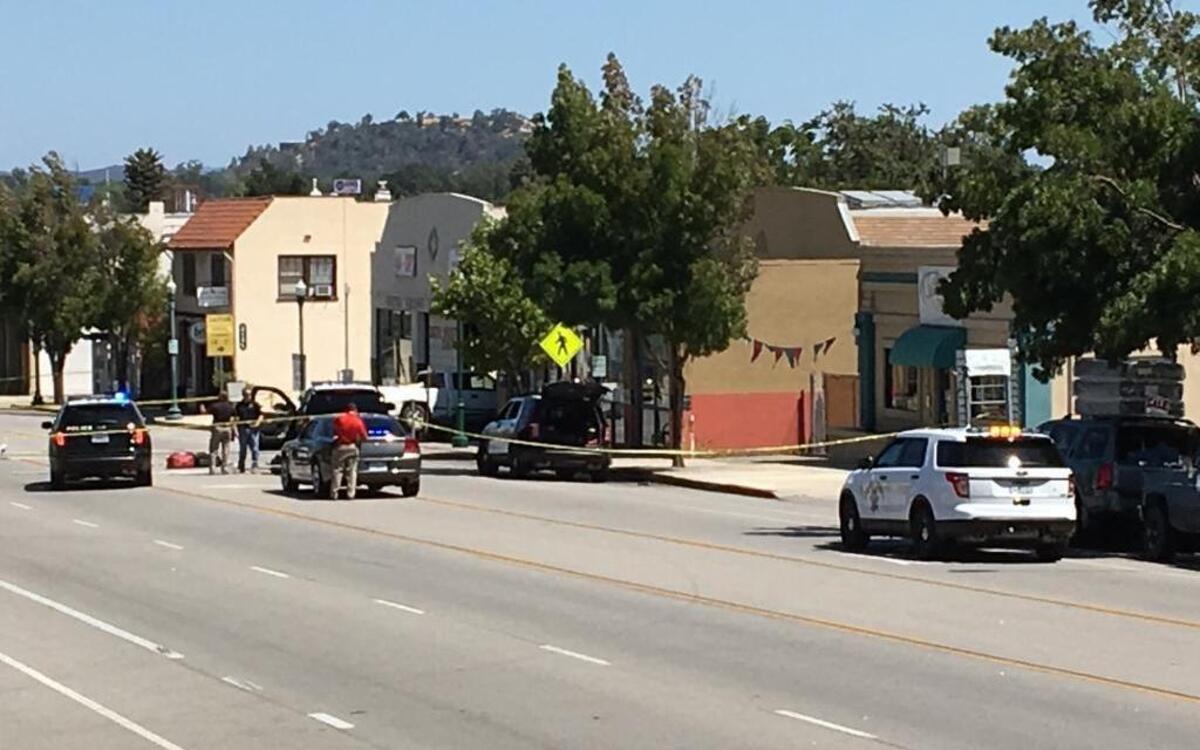 Police block off the scene of a reported officer-involved shooting in the 5600 block of El Camino Real in Atascadero. A truck appears to have crashed into the side of a building.