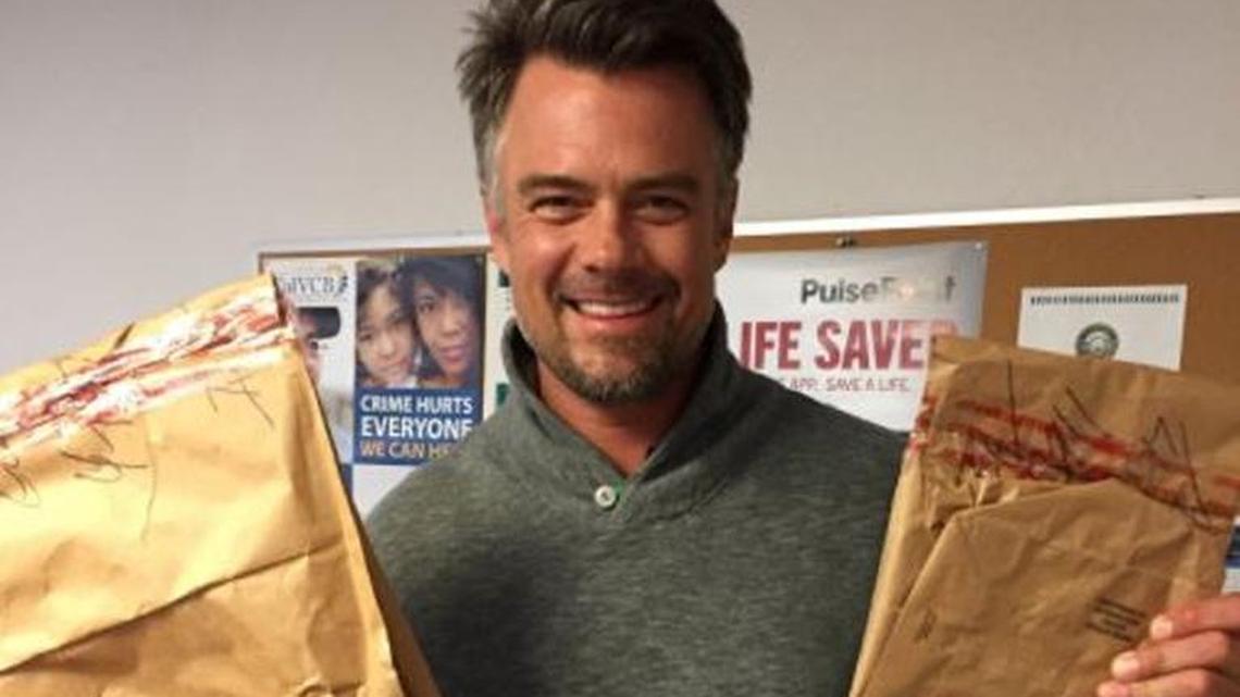 Actor Josh Duhamel poses with his recovered iPad and computer at the San Luis Obispo Police Department.