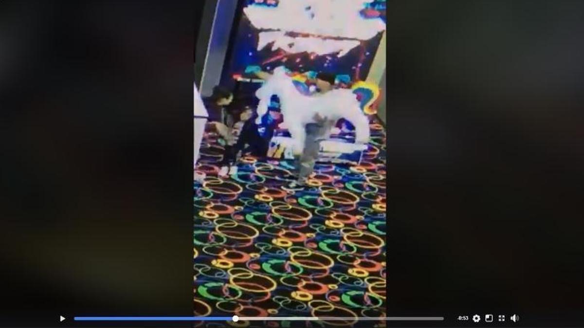 An unidentified man is seen holding a giant stuffed unicorn that he allegedly stole from The Slice Pizza & Games in Arroyo Grande, along with an unidentified woman and child.