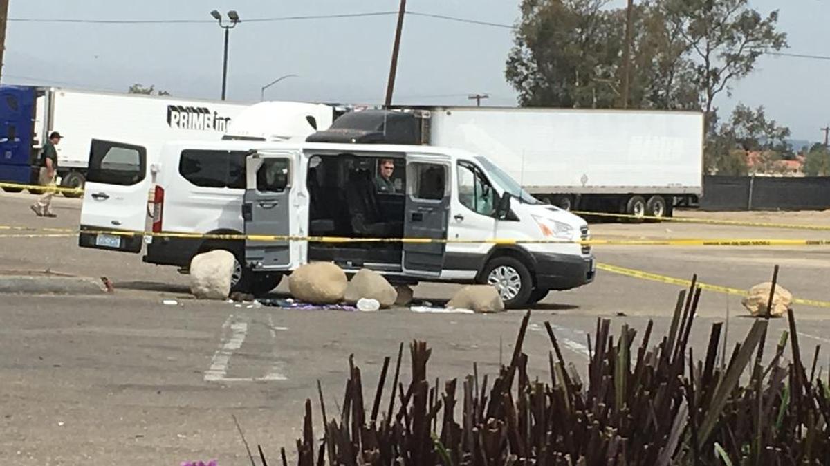 Crime tape surrounds the white van where an Oakland murder suspect was holed up Friday morning at a truck stop on Betteravia Road in Santa Maria.