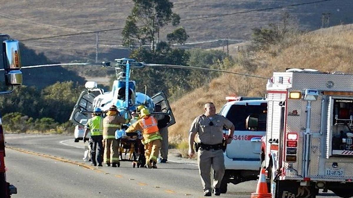 Emergency personnel take an injured person to a helicopter to be transported to the hospital after a rollover accident on Highway 1 north of Cayucos on Saturday afternoon.