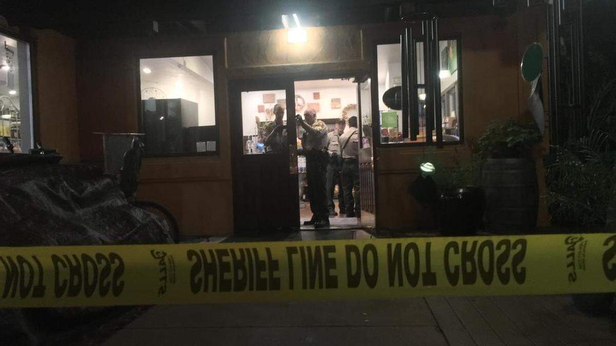 San Luis Obispo County Sheriff's deputies investigate the scene of an alleged armed robbery Friday night at the Sycamore Mineral Springs Resort in Avila Beach
