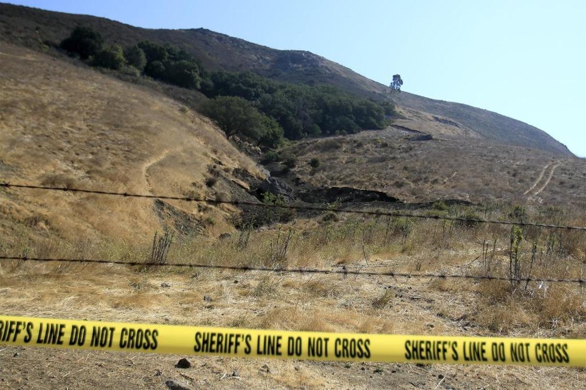Yellow tape cordons off the area where San Luis Obispo County Sheriff’s Office and FBI personnel are digging on the fourth day of a search for clues in September 2016. The search is focused on a campus hillside.