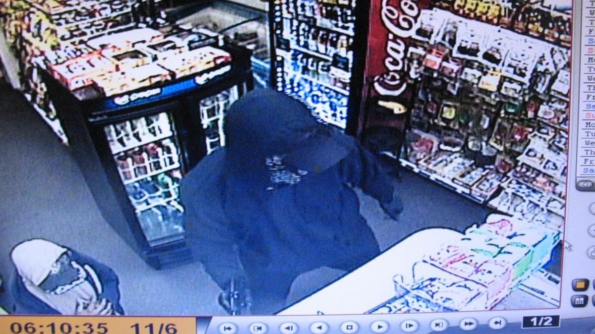 Security footage captures a man dressed in black as he robs a gas station in San Miguel on Sunday morning.