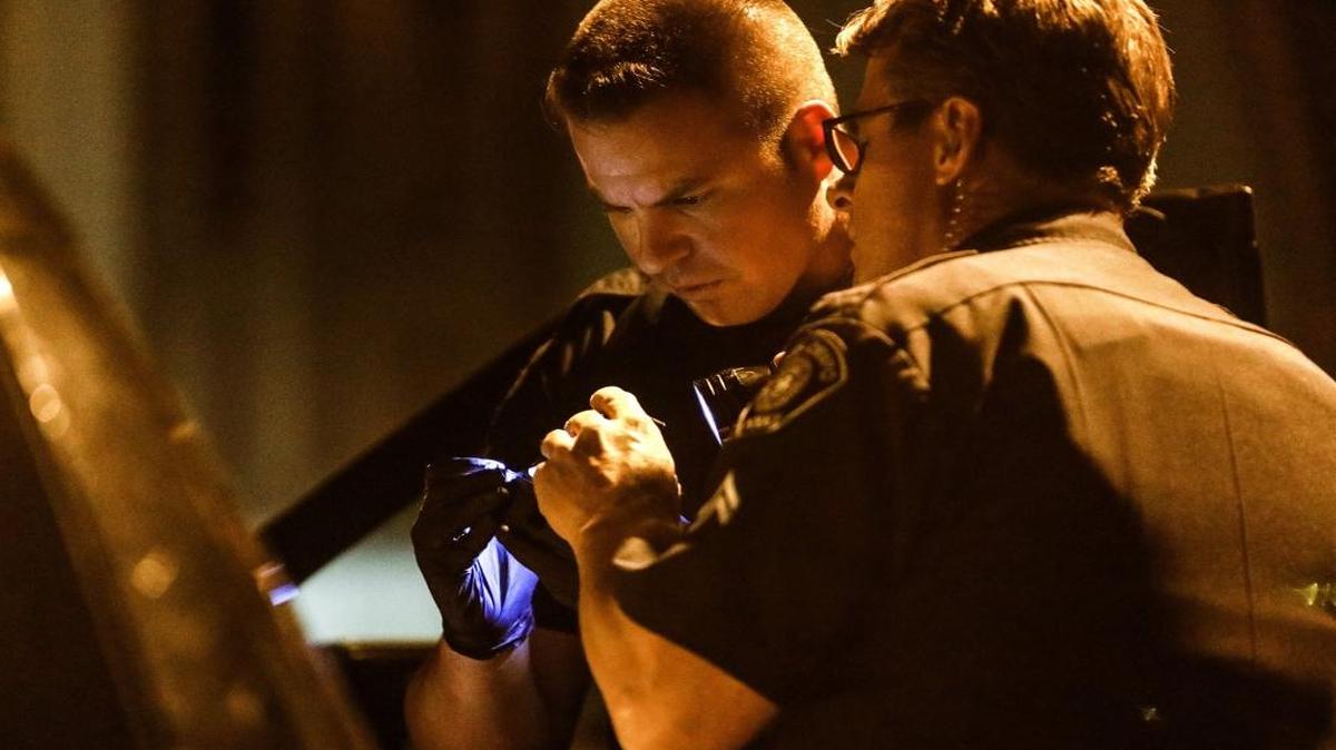 Officers look over a handgun seized from suspect at Silver City Mobile Park on Wednesday evening in San Luis Obispo.
