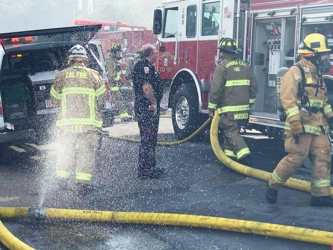 Firefighters work near the site of an apartment fire in Cambria on Monday morning.
