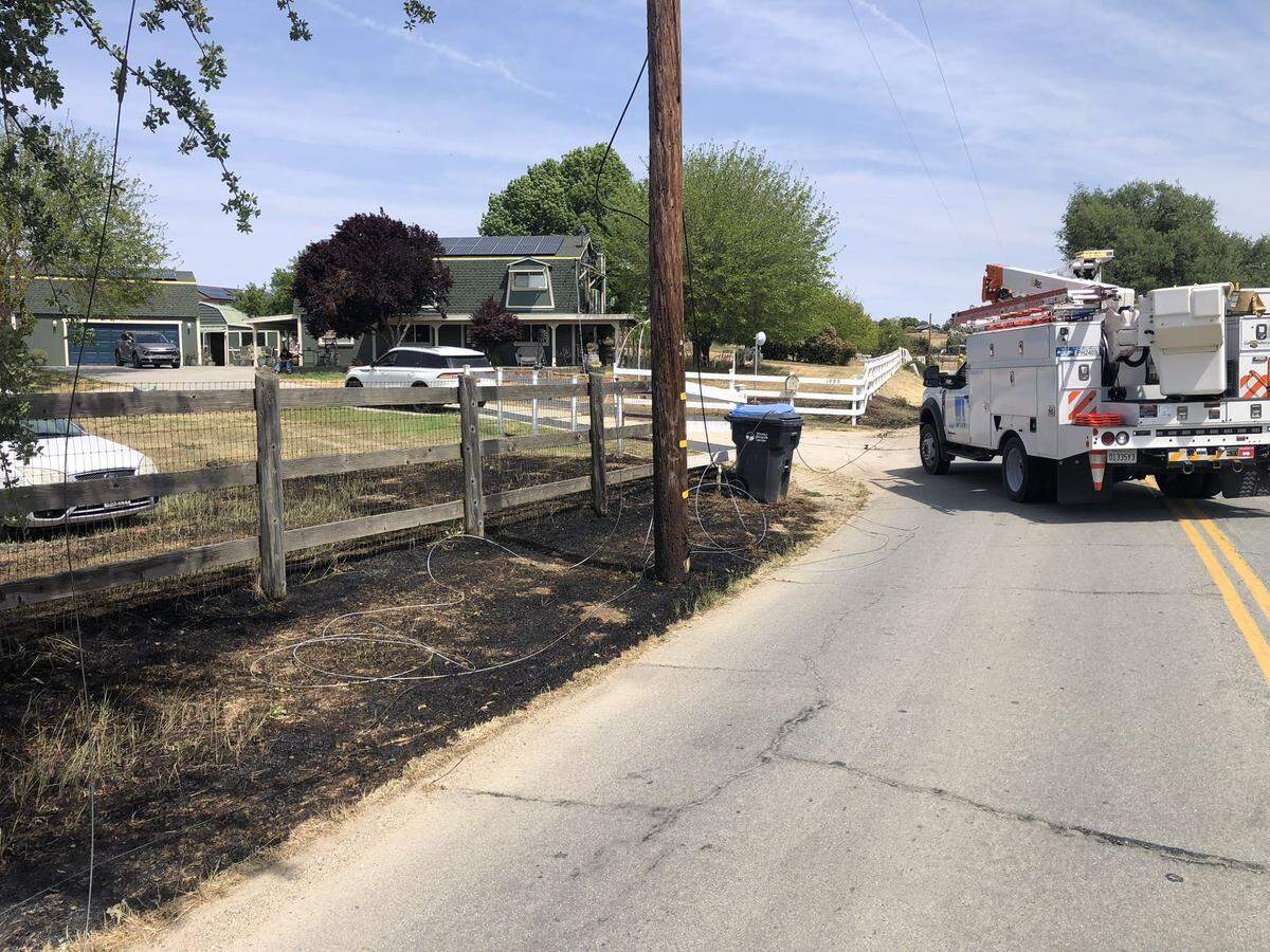Firefighters worked to extinguish three spot fires below PG&E power lines in Paso Robles on April 30, 2025.