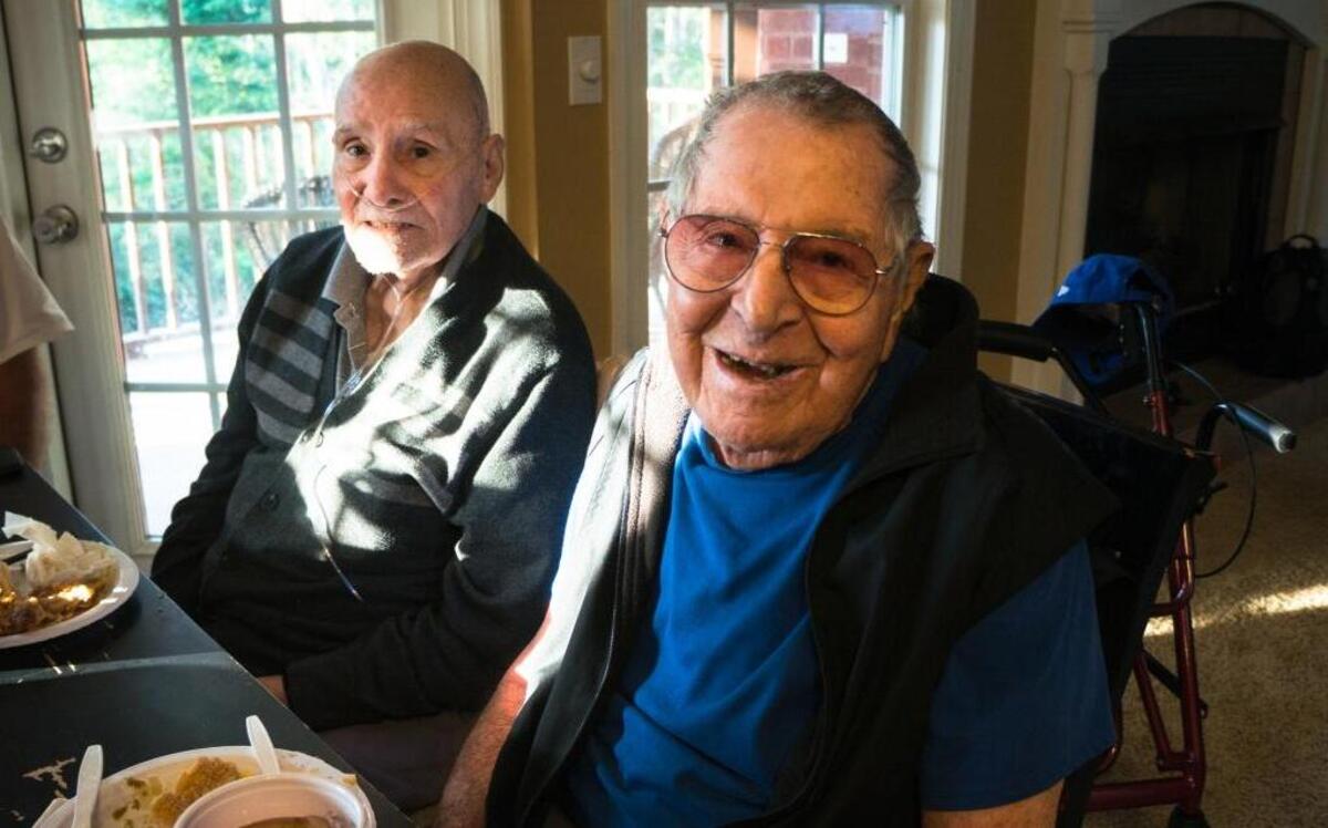 Lou Peluso, left, and his friend, Rudy, enjoy a meal after they arrived in Alabama. Marta Peluso drove the two elderly men for 17 hours in a bid to escape Hurricane Irma.