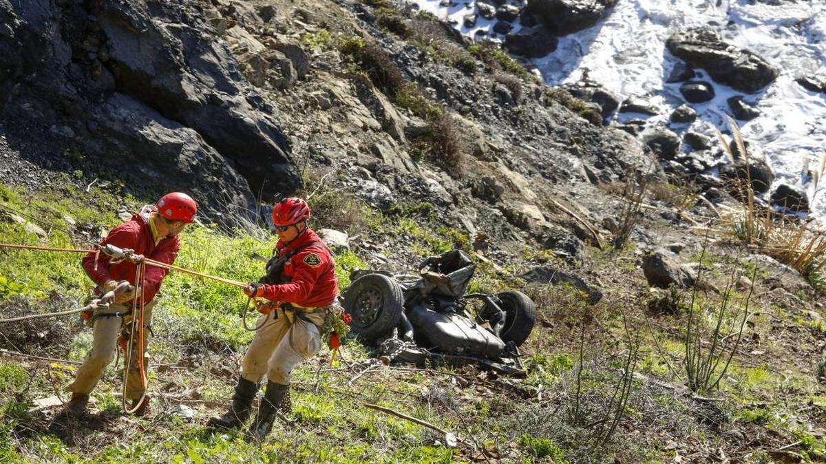 Members of the Monterey County Search and Rescue team prepare to attach a second length of cable for the second pull on the first part of the car brought up. Officials from Monterey County Search and Rescue, San Luis Obispo County Search and Rescue and CHP with the assistance of two tow truck crews were lifting the pieces of a car that went off the cliff near Ragged Point.