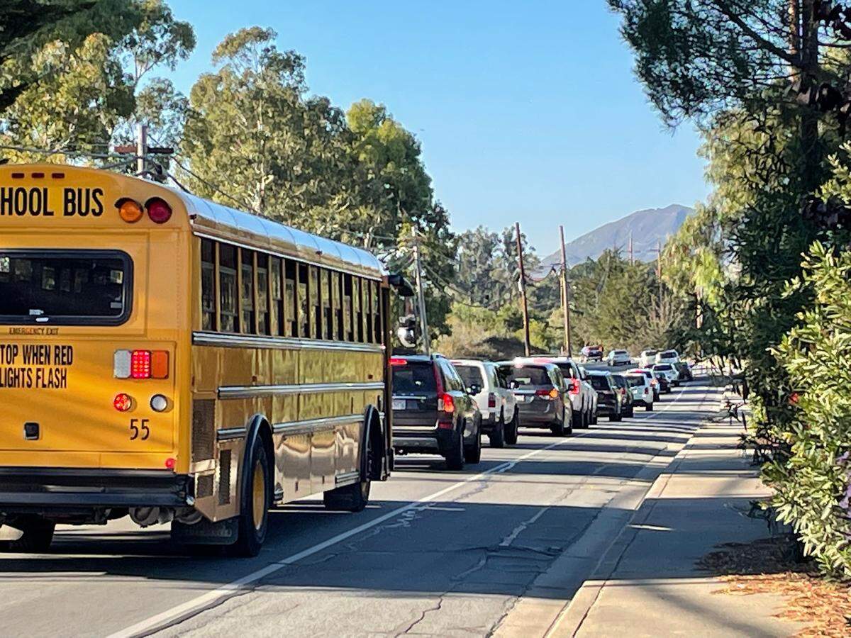 Buses line up along Los Ranchos Road on their way to Highway 227 after school lets out of Los Ranchos Elementary. 