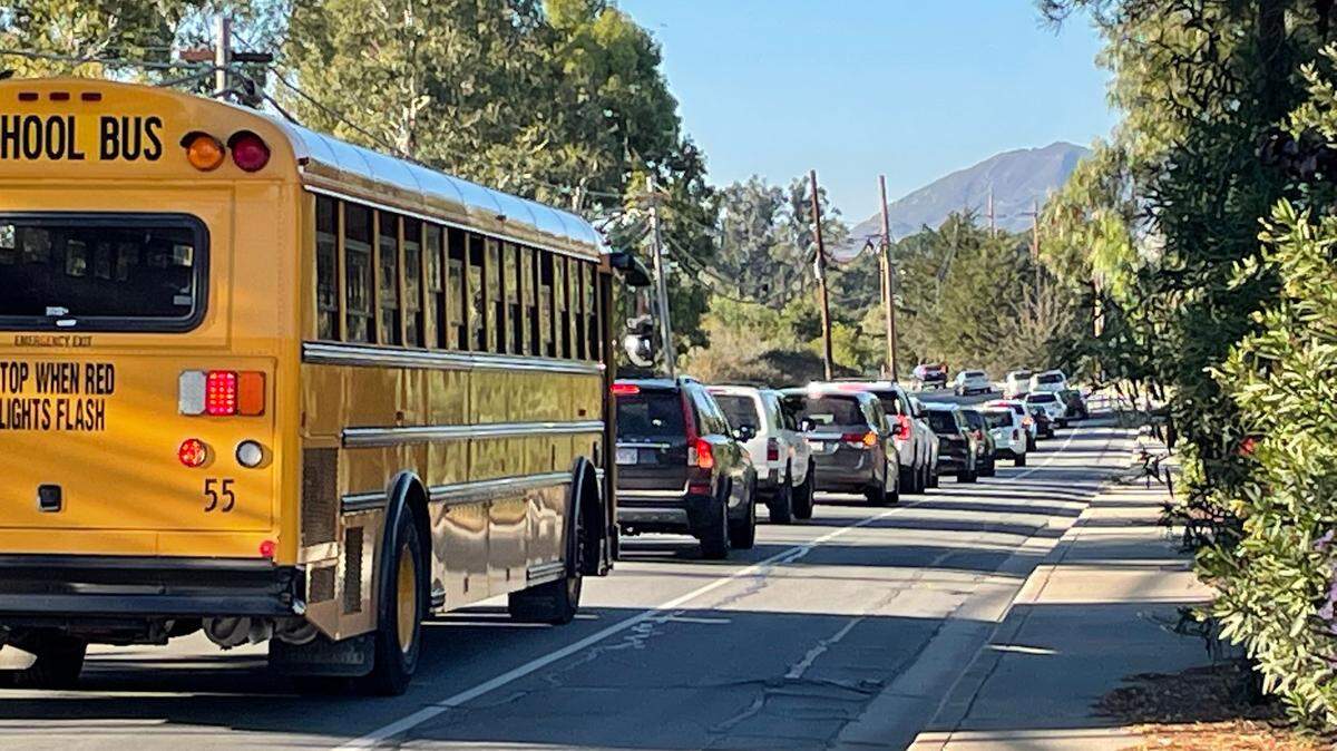 Buses line up along Los Ranchos Road on their way to Highway 227 after school lets out of Los Ranchos Elementary. 