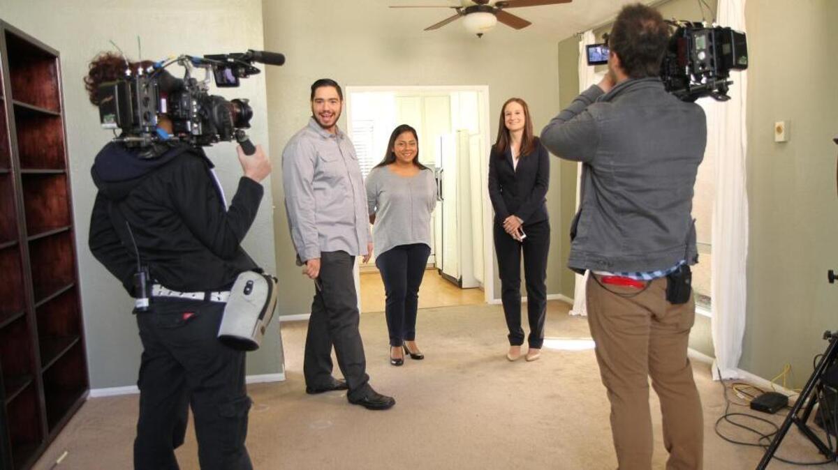Jimmy and Orchid Ochoa and their real estate agent Lindsey Harn participate in the filming of an episode of the TLC reality show “My First Home.”