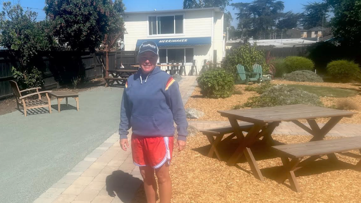 Jennifer Dorn, new owner of the Merrimaker in Baywood, stands in the bar’s beer garden.