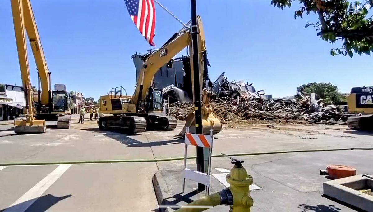 A demolition team brought down the southern portion of the burned-out Templeton Feed & Grain building on Monday, July, 7, 2025, after a fire gutted the historic granary on the Fourth of July.